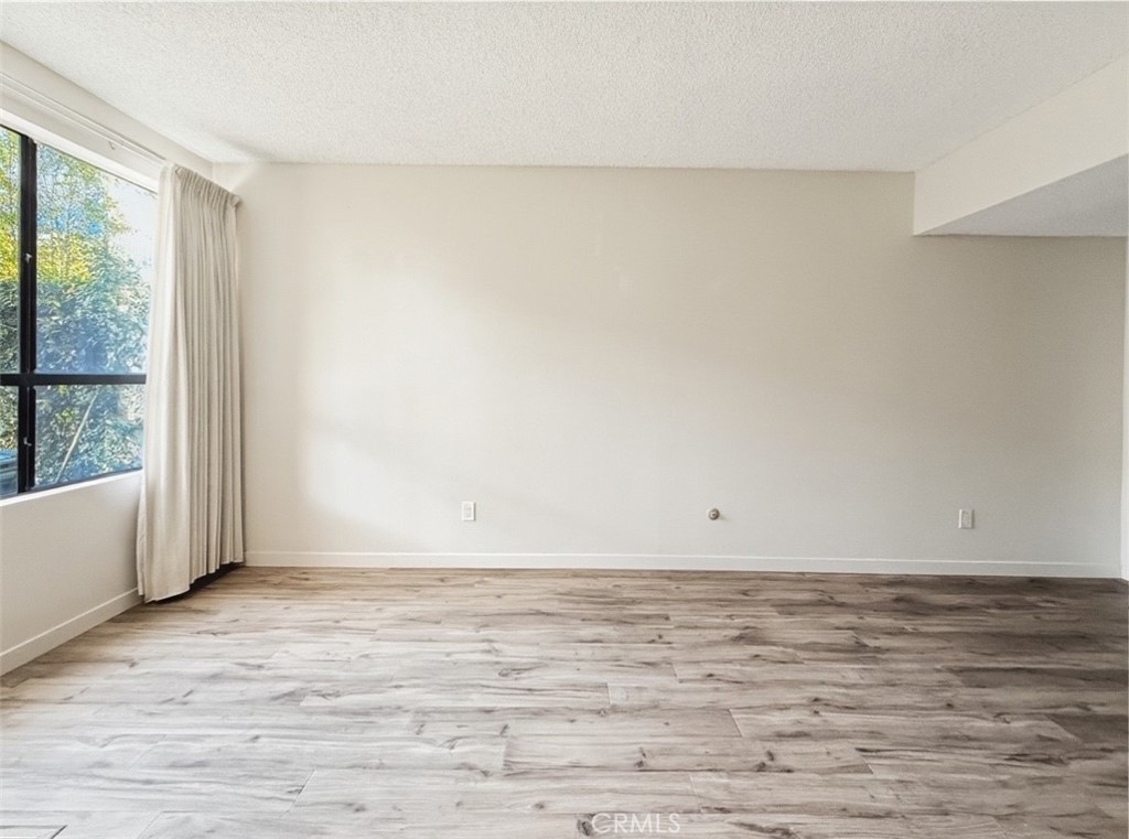 415 West Duarte Road, Unit 2 Arcadia, CA 91007 - Photo 2 of 30 a view of an empty room with wooden floor and a window