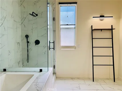 a bathroom with a bathtub and shower