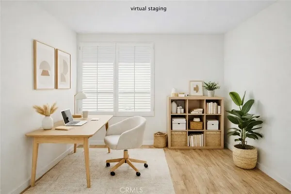 a view of a workspace with furniture and a potted plant