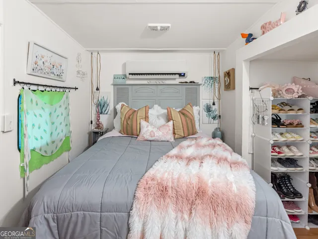 a bedroom with a bed and a window