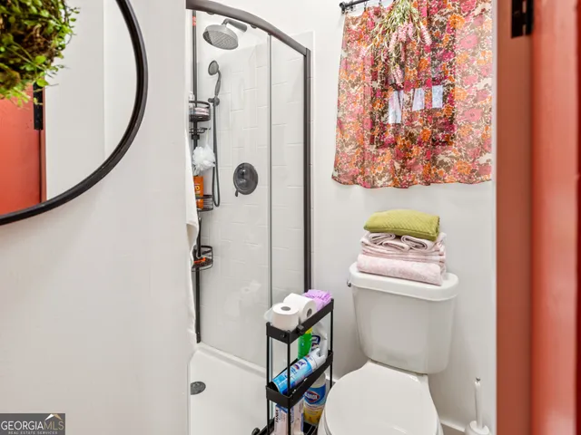 a white toilet sitting next to a bathroom sink