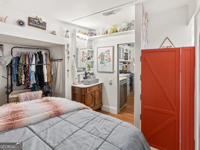 a bedroom with a bed and a refrigerator