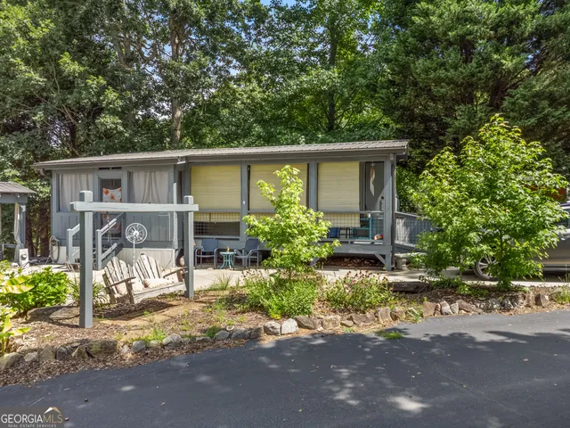 a view of a house with backyard and sitting area