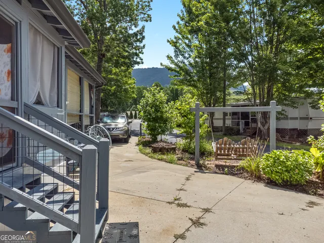a view of a house with sitting area and garden