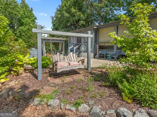 a view of a house with a yard balcony and table