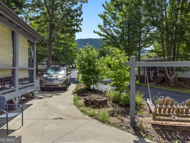 a view of a patio with table and chairs and potted plants