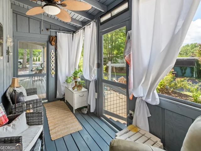 a living room with furniture and a floor to ceiling window