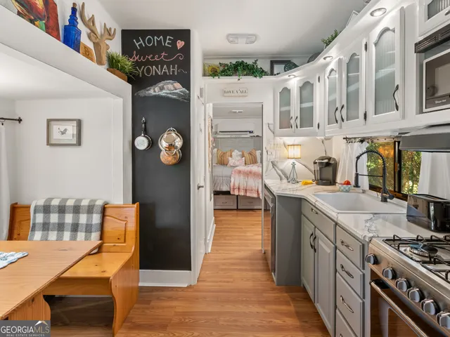a kitchen with stainless steel appliances granite countertop a stove and a dining table