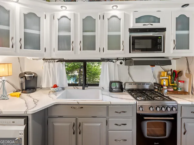 a kitchen with stainless steel appliances a stove and a sink