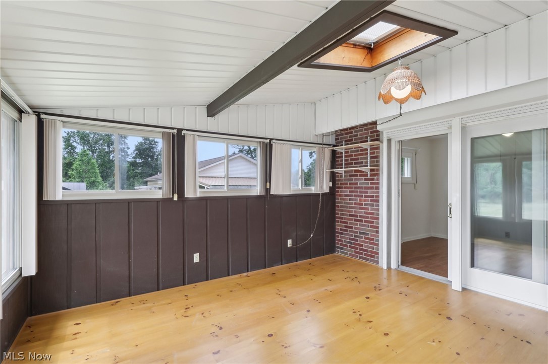 3873 Baumberger Road Stow, OH 44224 - Photo 27 of 50 sunroom featuring lofted ceiling with skylight