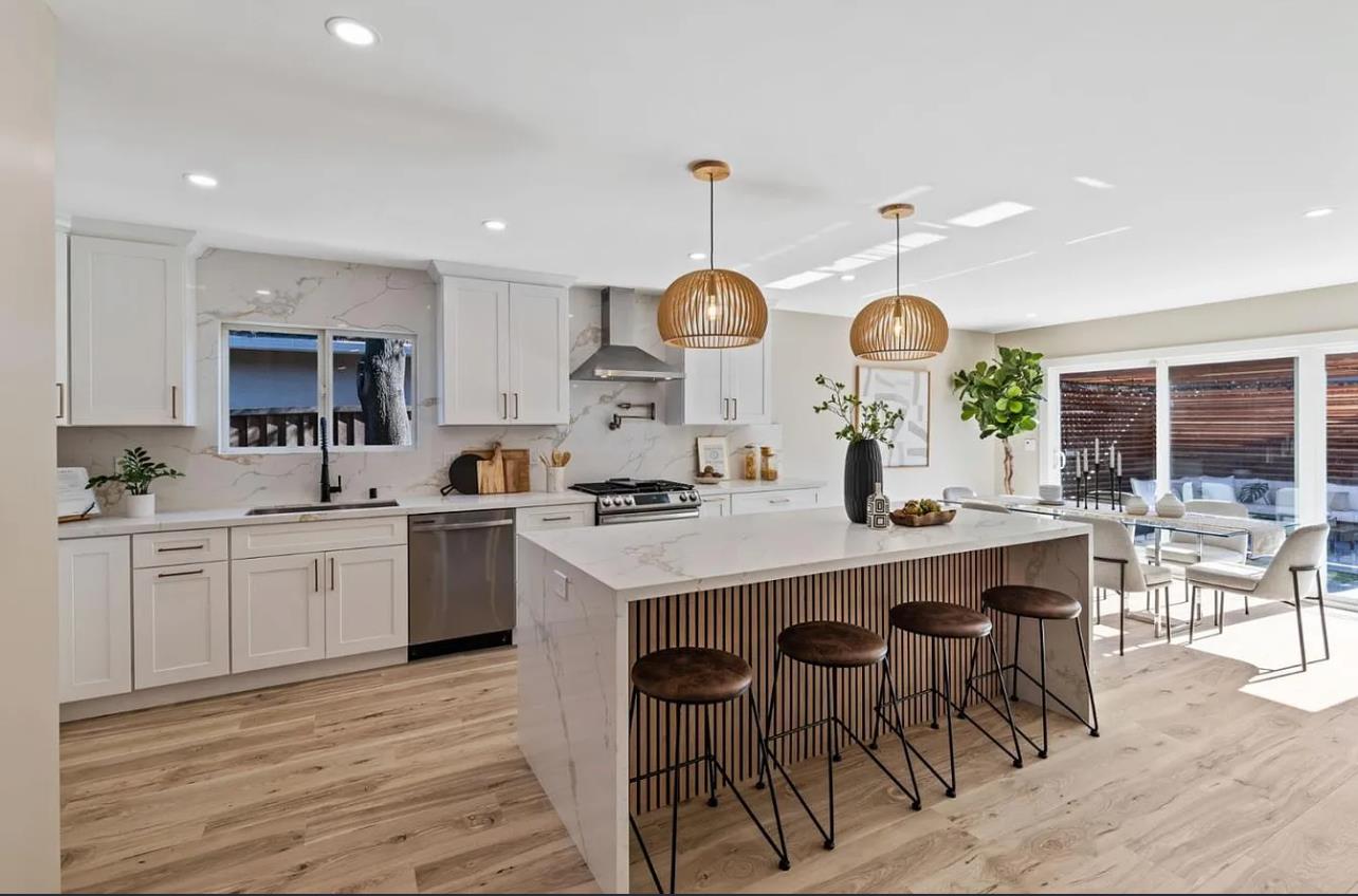 1439 Bittern Drive Sunnyvale, CA 94087 - Photo 2 of 28 a large kitchen with cabinets a sink a stove and chairs