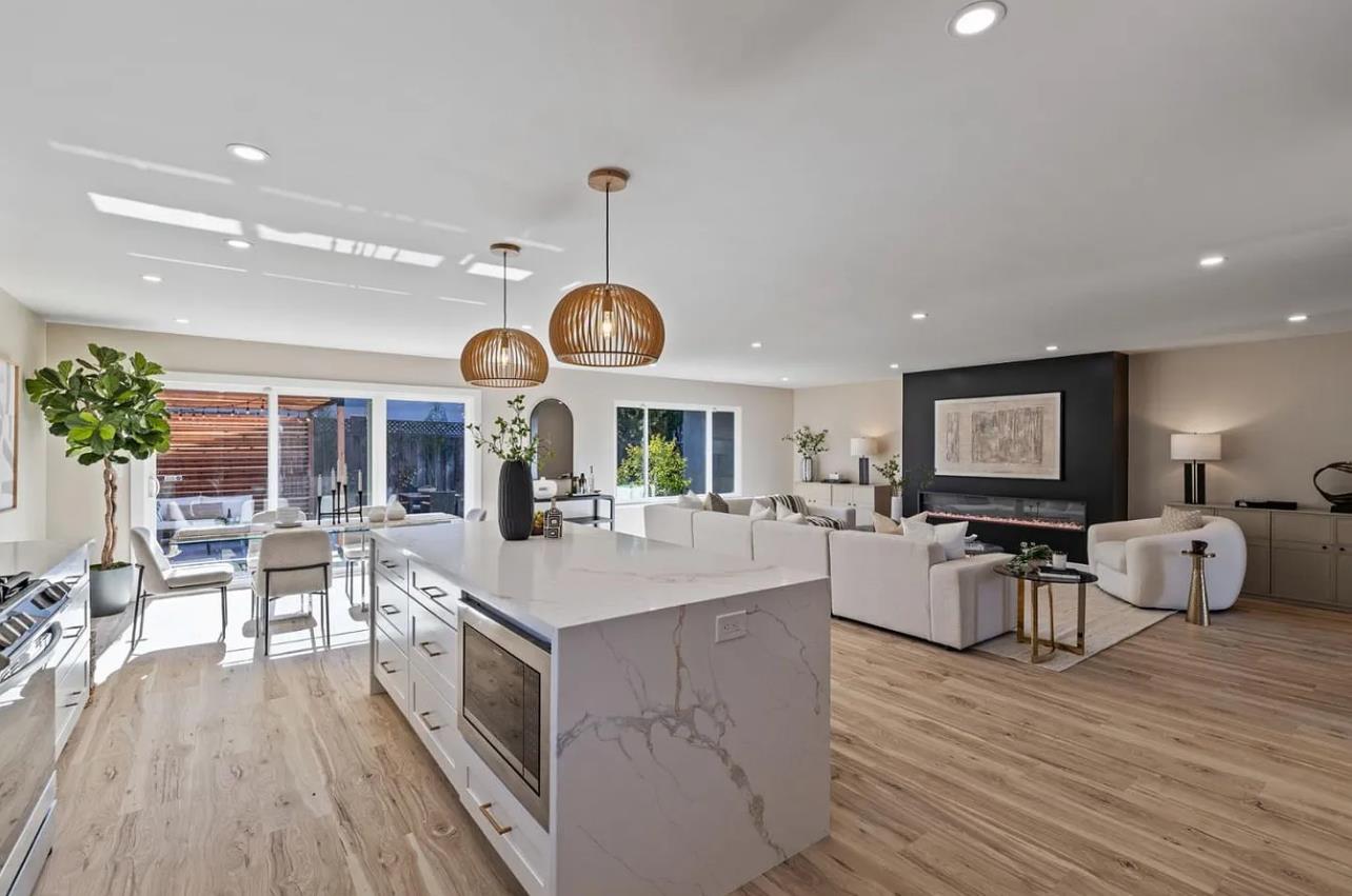 1439 Bittern Drive Sunnyvale, CA 94087 - Photo 5 of 28 a large kitchen with stainless steel appliances a stove center island wooden floor and living room view