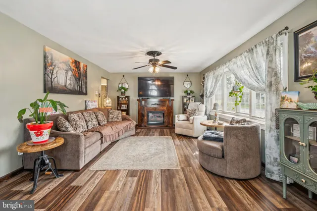 a living room with fireplace furniture and a wooden floor