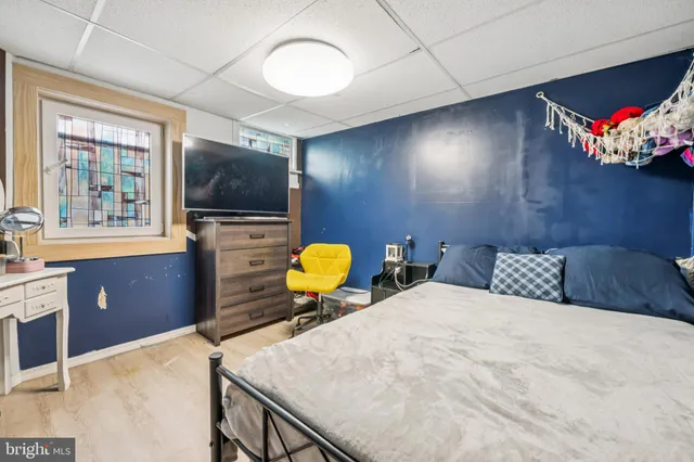 a bedroom with a bed and glass wall mirror