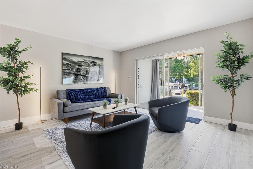 1320 Blue Point Avenue, Unit 2 Naples, FL 34102 - Photo 12 of 35 a living room with furniture potted plant and a window