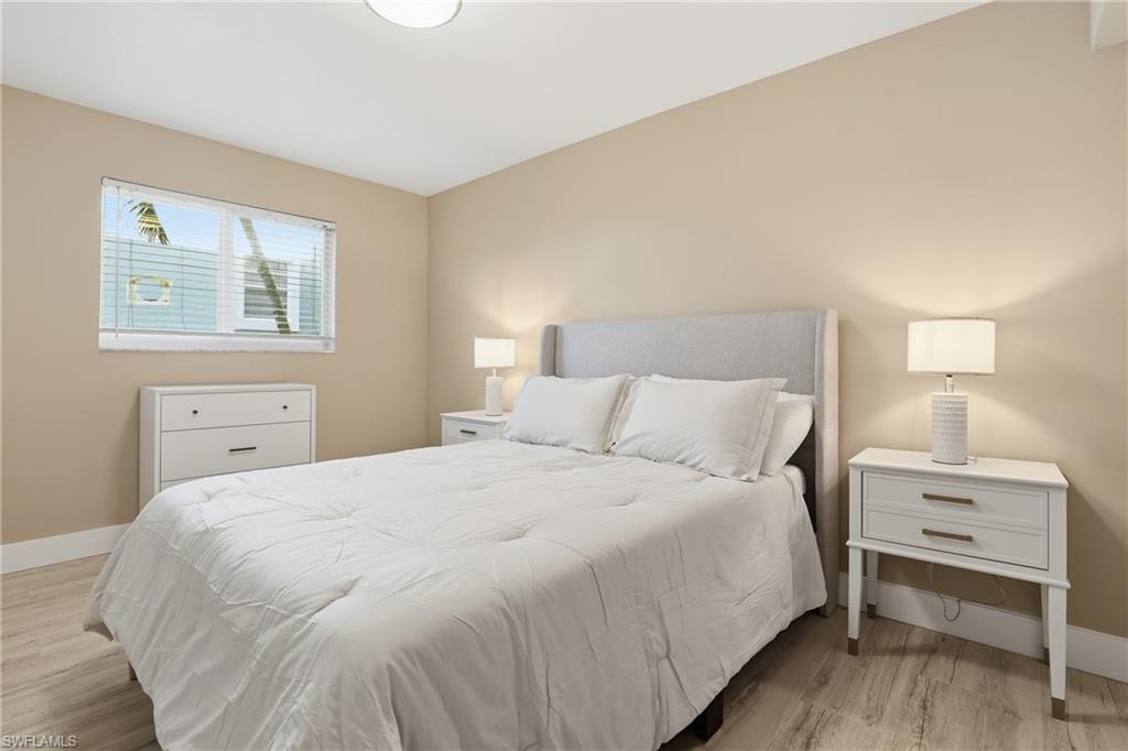 1320 Blue Point Avenue, Unit 2 Naples, FL 34102 - Photo 13 of 35 a bedroom with a bed and a desk