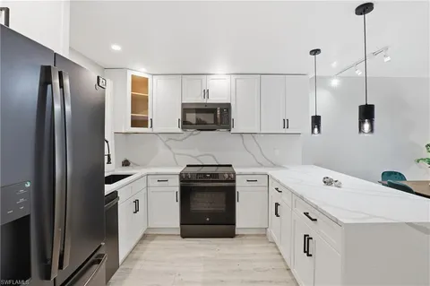 a kitchen with a sink stove and refrigerator