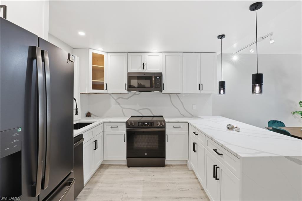 1320 Blue Point Avenue, Unit 2 Naples, FL 34102 - Photo 16 of 35 a kitchen with a sink stove and refrigerator