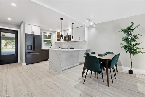 a kitchen with a table and chairs in it