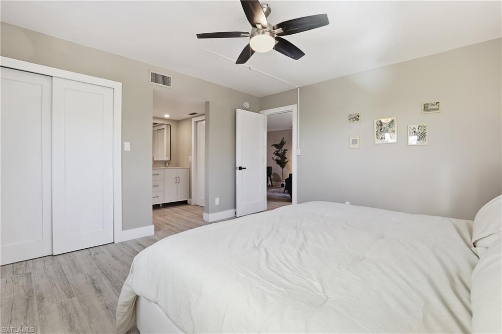 1320 Blue Point Avenue, Unit 2 Naples, FL 34102 - Photo 24 of 35 a spacious bedroom with a bed and a ceiling fan