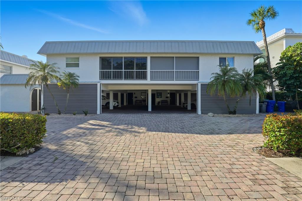 1320 Blue Point Avenue, Unit 2 Naples, FL 34102 - Photo 27 of 35 a view of a house with a yard and potted plants