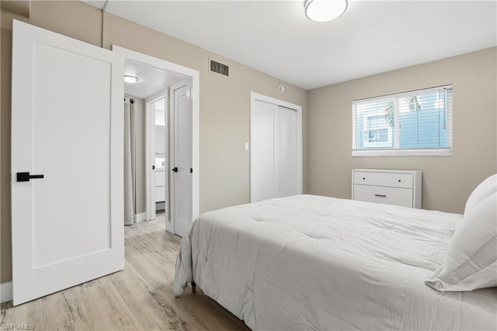 1320 Blue Point Avenue, Unit 2 Naples, FL 34102 - Photo 30 of 35 a bedroom with a bed and a window