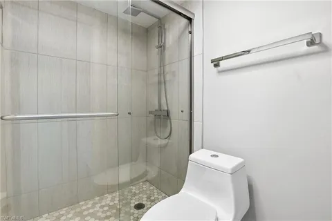 a bathroom with a toilet and shower