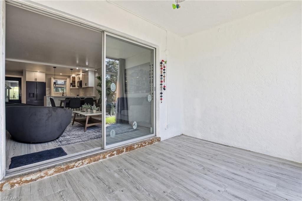 1320 Blue Point Avenue, Unit 2 Naples, FL 34102 - Photo 8 of 35 a room with wooden floor and furniture