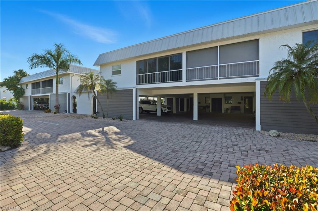 1320 Blue Point Avenue, Unit 2 Naples, FL 34102 - Photo 9 of 35 a front view of a house with a yard