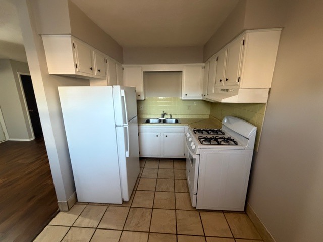 107 College Park Court, Unit 2 Normal, IL 61761 - Photo 4 of 8 a kitchen with a refrigerator a stove top oven and cabinets