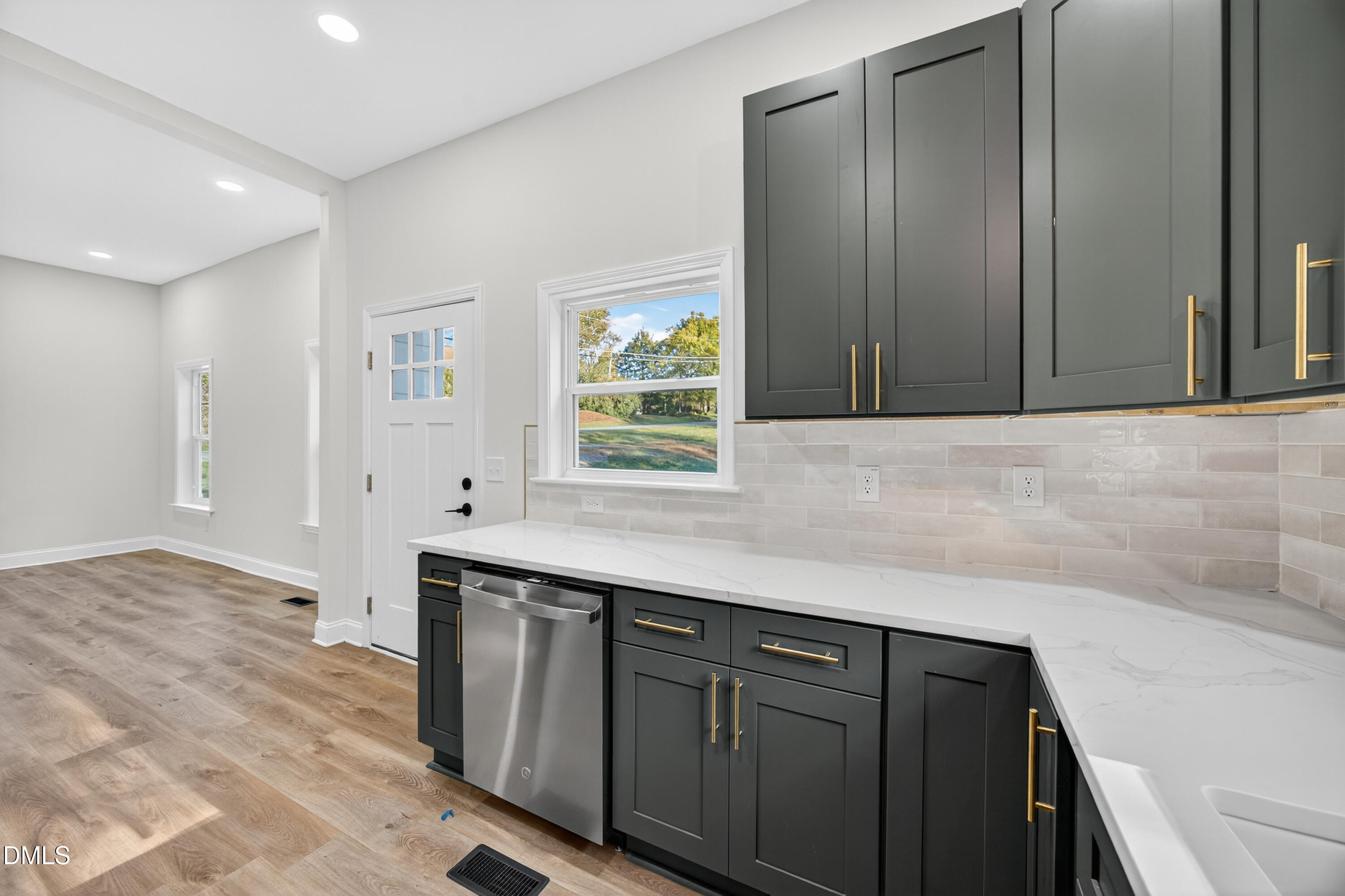 1043 George Bason Road Graham, NC 27253 - Photo 13 of 30 a kitchen with stainless steel appliances granite countertop a sink and dishwasher with wooden cabinets