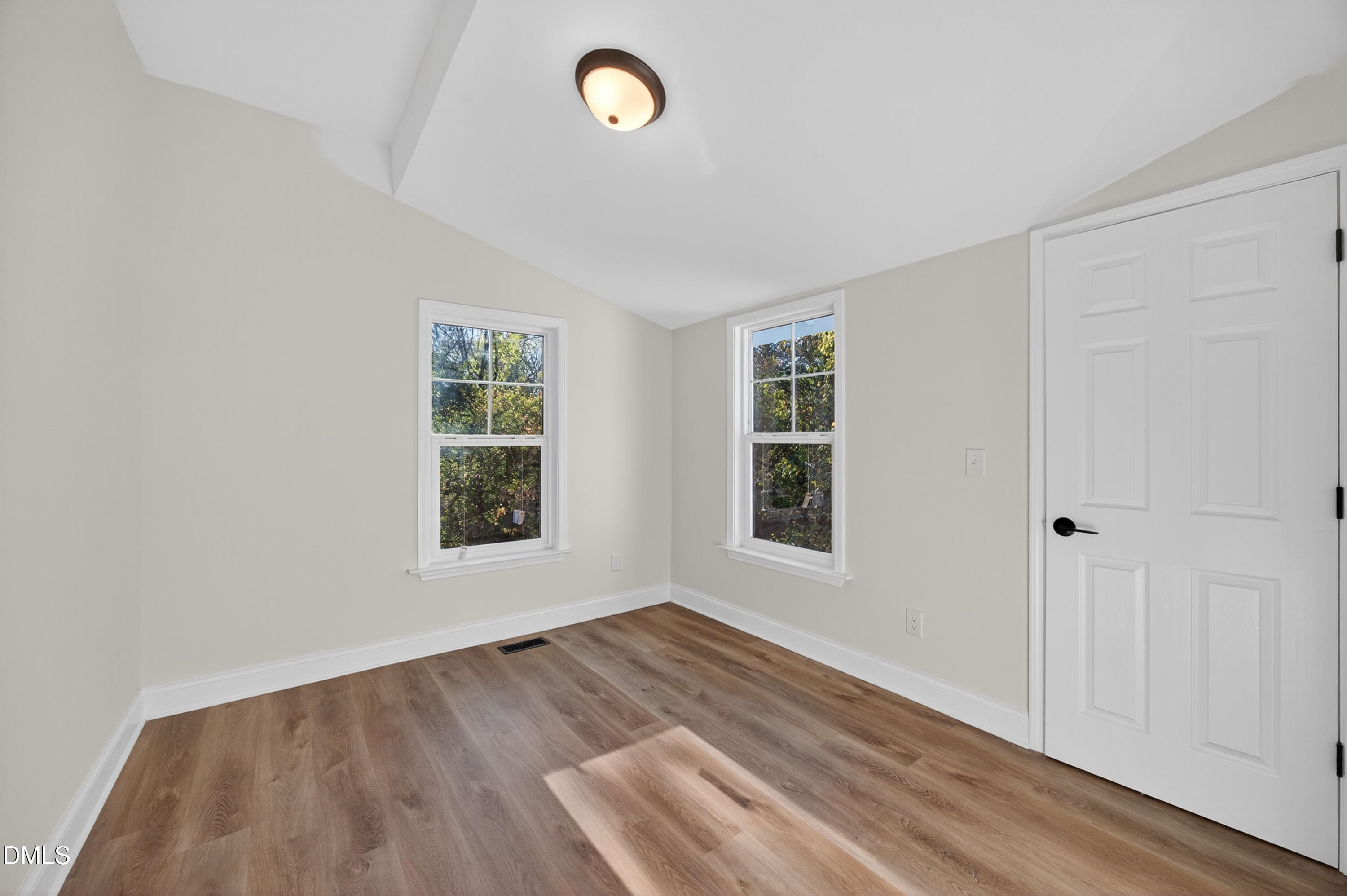 1043 George Bason Road Graham, NC 27253 - Photo 14 of 30 an empty room with wooden floor and windows