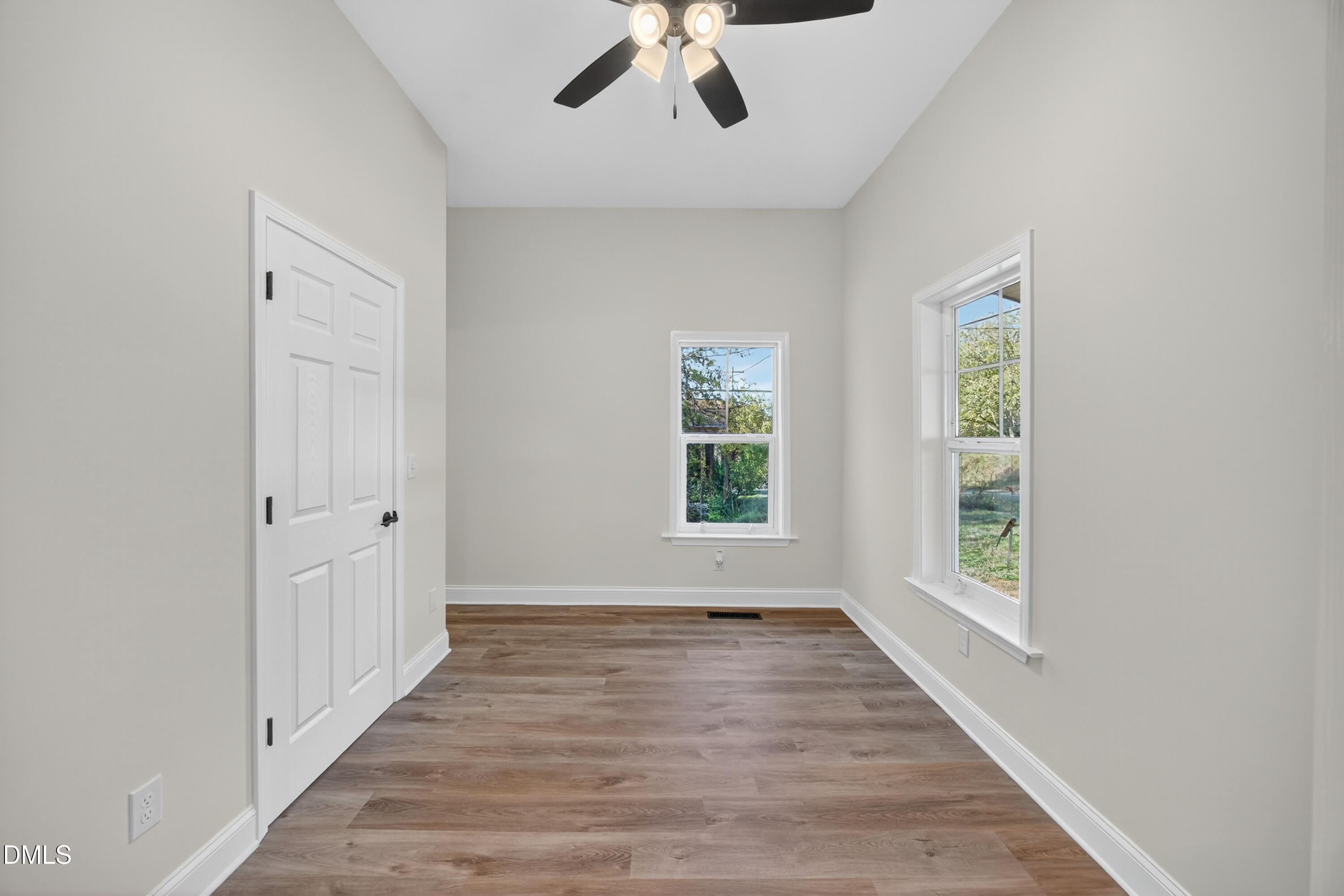 1043 George Bason Road Graham, NC 27253 - Photo 17 of 30 an empty room with wooden floor chandelier and windows