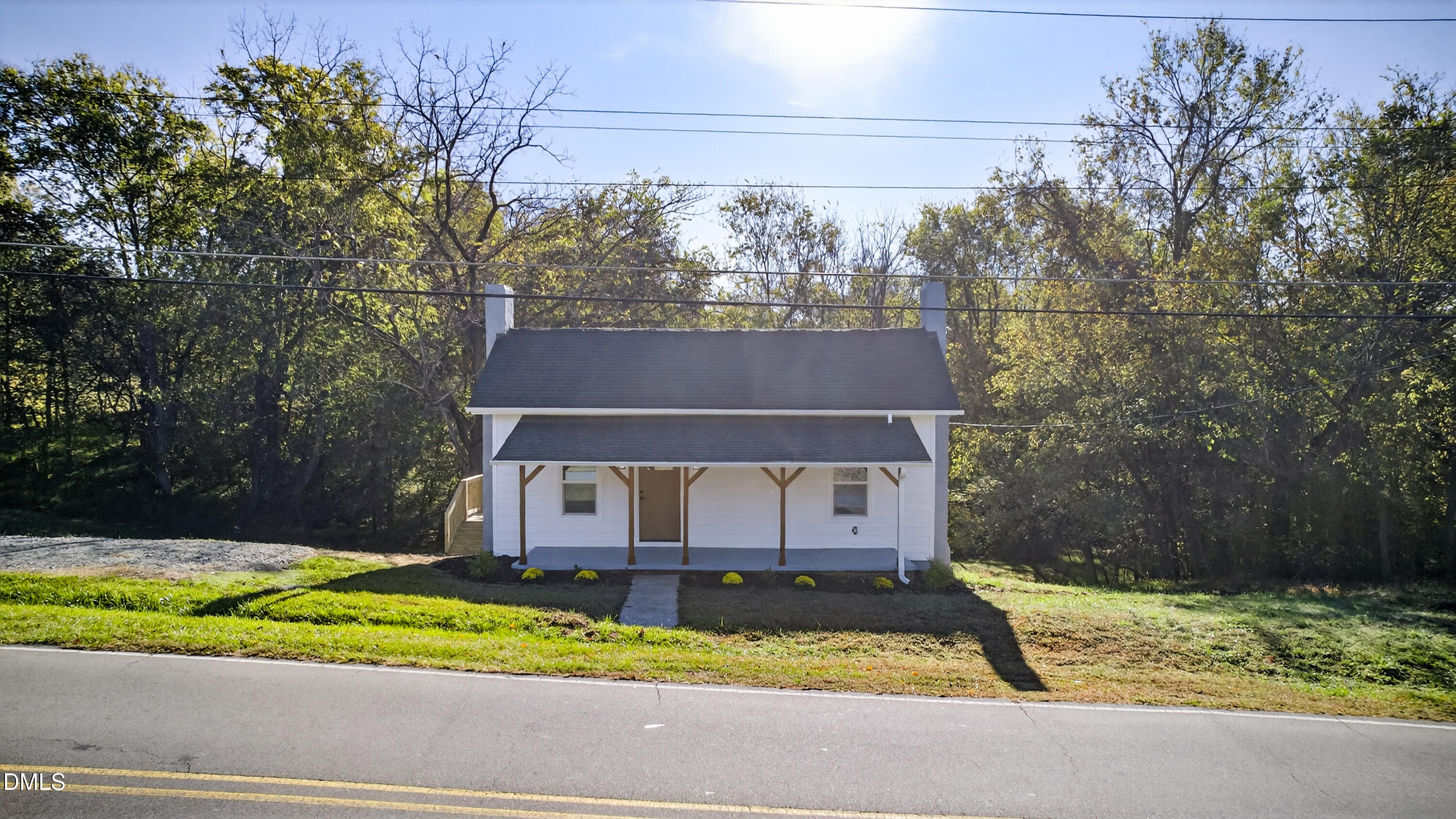 1043 George Bason Road Graham, NC 27253 - Photo 27 of 30 a front view of house with a yard and large trees