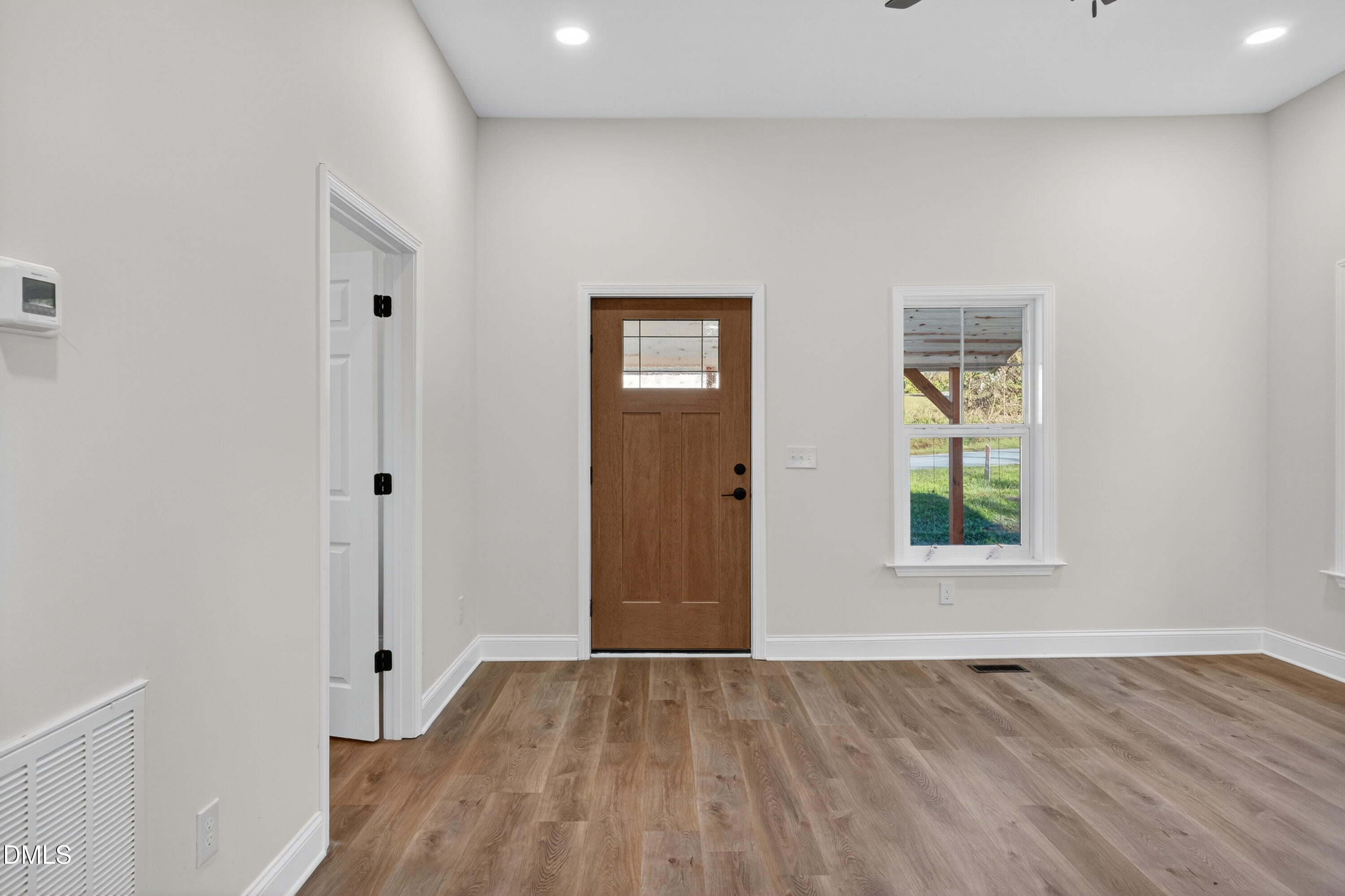 1043 George Bason Road Graham, NC 27253 - Photo 8 of 30 an empty room with wooden floor and windows