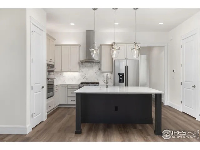 a kitchen with cabinets stainless steel appliances and wooden cabinets