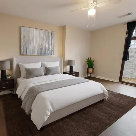 a bedroom with a large bed and a chandelier