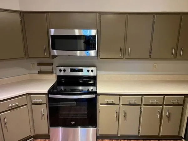 a kitchen with granite countertop a stove and a microwave
