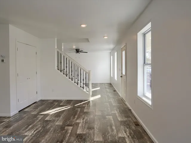 a view of an entryway with wooden floor