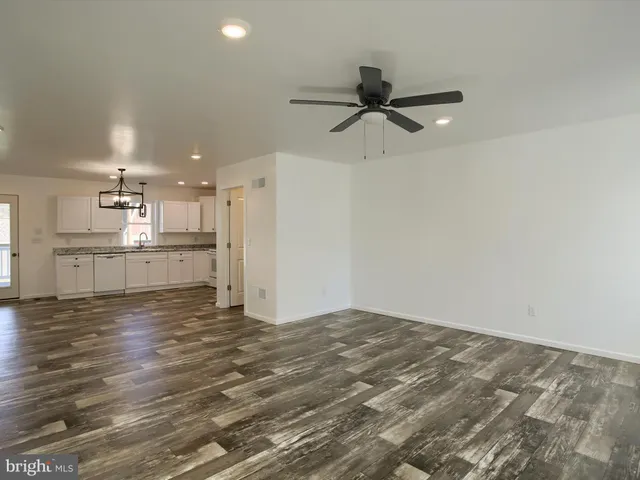 a view of a kitchen with a sink and cabinets