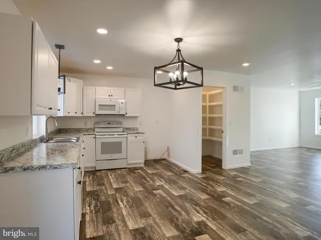 a kitchen with stainless steel appliances granite countertop a stove and a refrigerator