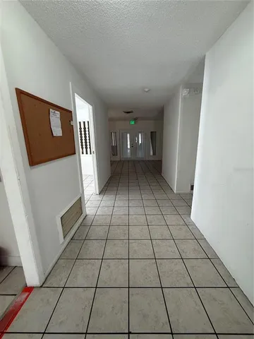 a view of a livingroom with an empty space and a window