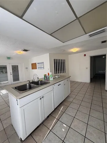 a kitchen with a stove a sink and a refrigerator