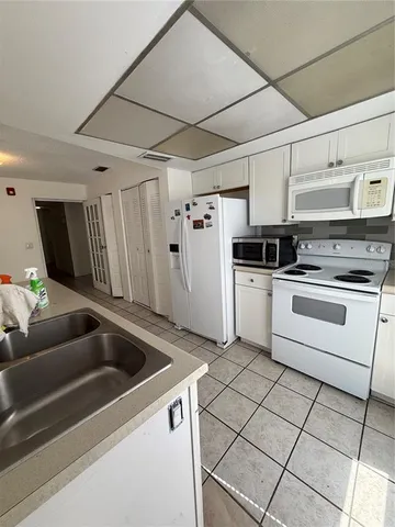 a kitchen with stainless steel appliances kitchen island granite countertop a sink and cabinets
