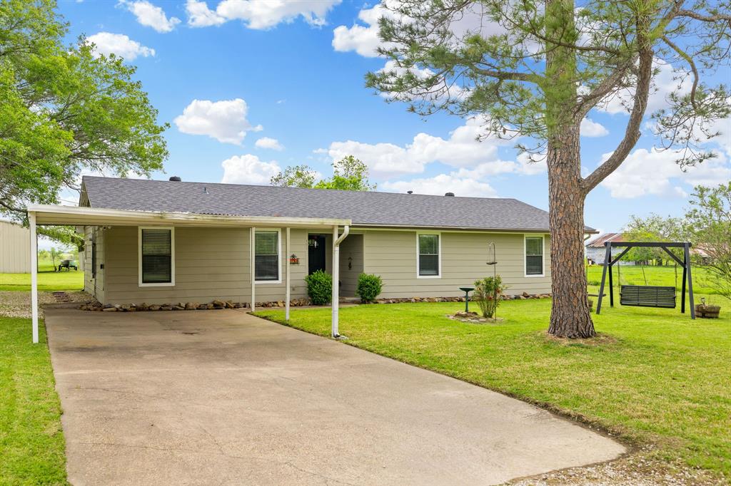 a view of a house with backyard porch and garden