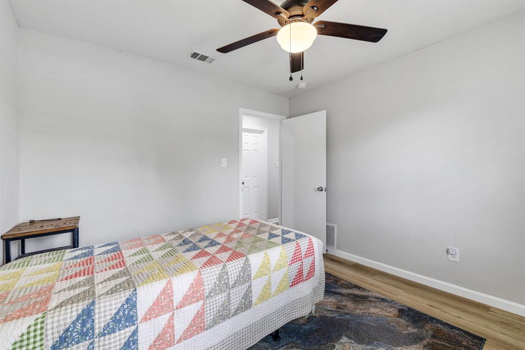 191 Klutts Road McLendon-Chisholm, TX 75032 - Photo 24 of 40 a bedroom with a bed and a chandelier