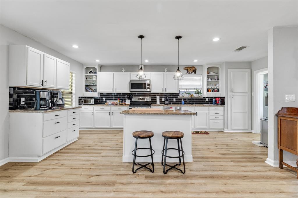 191 Klutts Road McLendon-Chisholm, TX 75032 - Photo 4 of 40 a kitchen with stainless steel appliances granite countertop a refrigerator a stove top oven a sink and cabinets