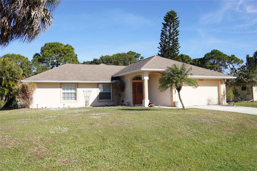 7546 Ebro Road Englewood, FL 34224 - Photo 1 of 1 a house with trees in the background