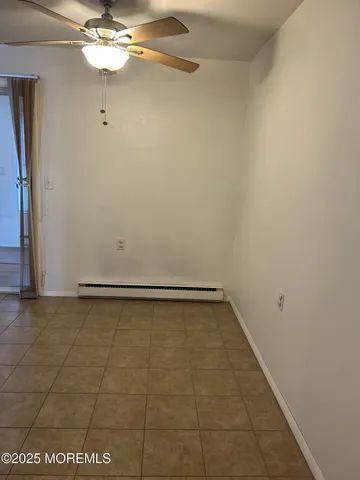 a view of a room with an empty space and a ceiling fan