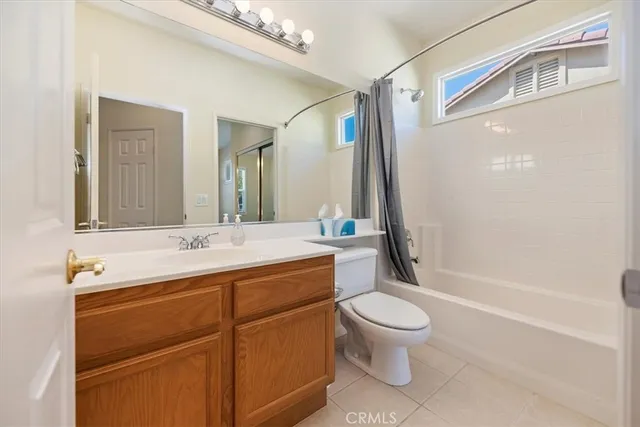 a bathroom with a sink a toilet and a large mirror